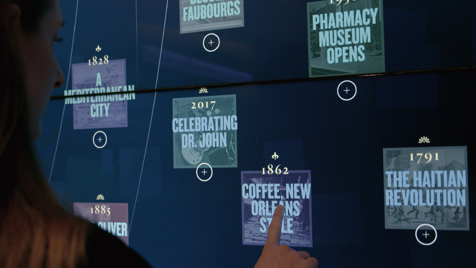 Visitor browsing the year tiles Visitor reaching toward year tiles on the interactive media wall, spanning 1791 to 2017