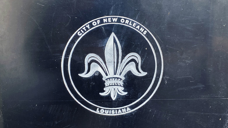 City of New Orleans seal City of New Orleans fleur-de-lis seal on a weathered dark ground