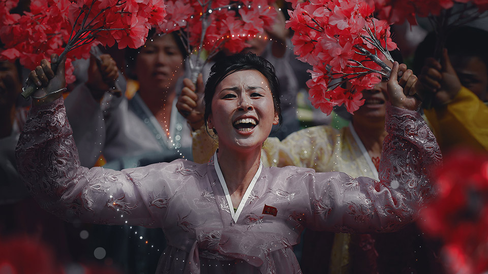 Redesigned particle treatment Performer holding red blossoms, overlaid with the redesigned particle treatment