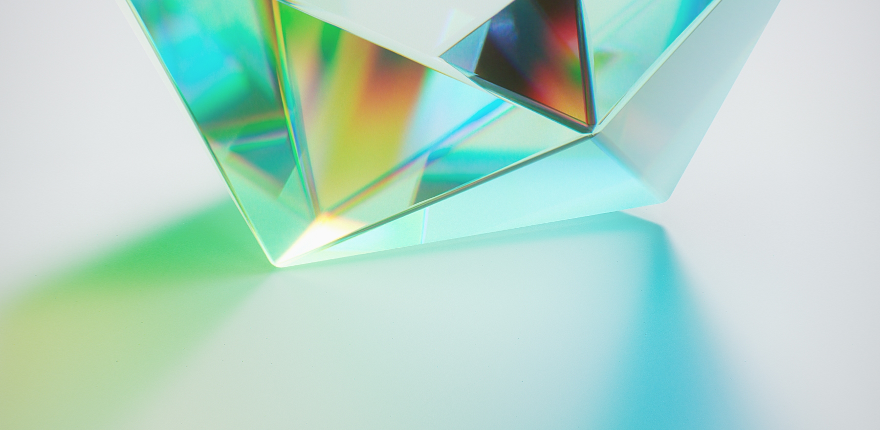 Prism refracting light Glass prism refracting light into a spectrum across a pale surface